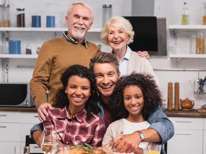 A happy family at their dinner table.